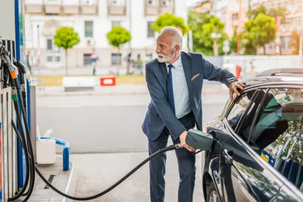 A lawyer uses a fleet card to fuel his firm’s car at a gas station.