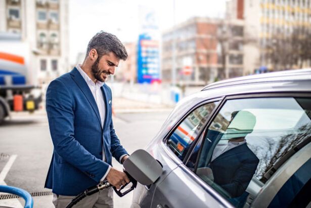 A lawyer uses his fuel card to gas up his company vehicle.