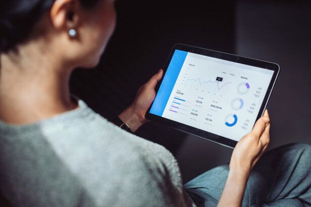 A commercial cleaning business owner reviews analytics from her fleet card on a tablet.