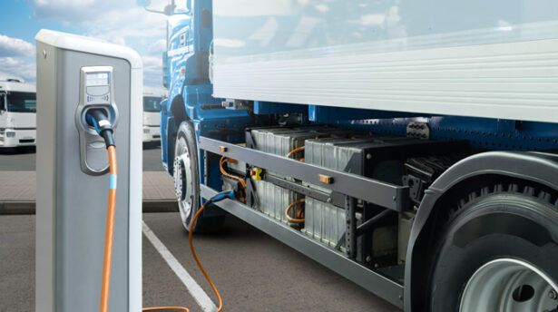 An electric semi-truck from a fleet charging with a fleet card at an EV charging station.