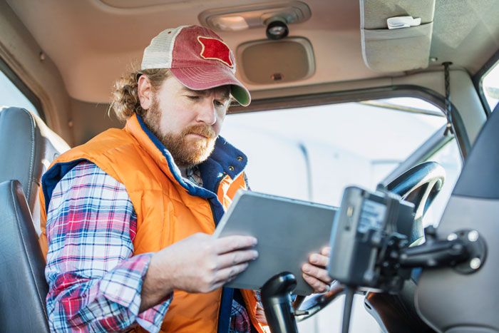 An HVAC worker reviews his route before heading out on his HVAC route.