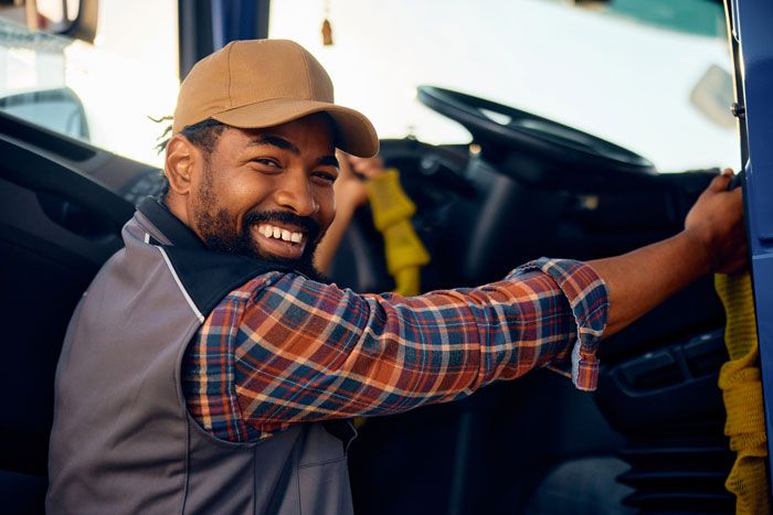 A fleet driver prepares to get in his truck after filling up with a fuel card.