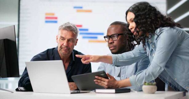 A business team reviews fuel card data in real-time from their computers at the office.